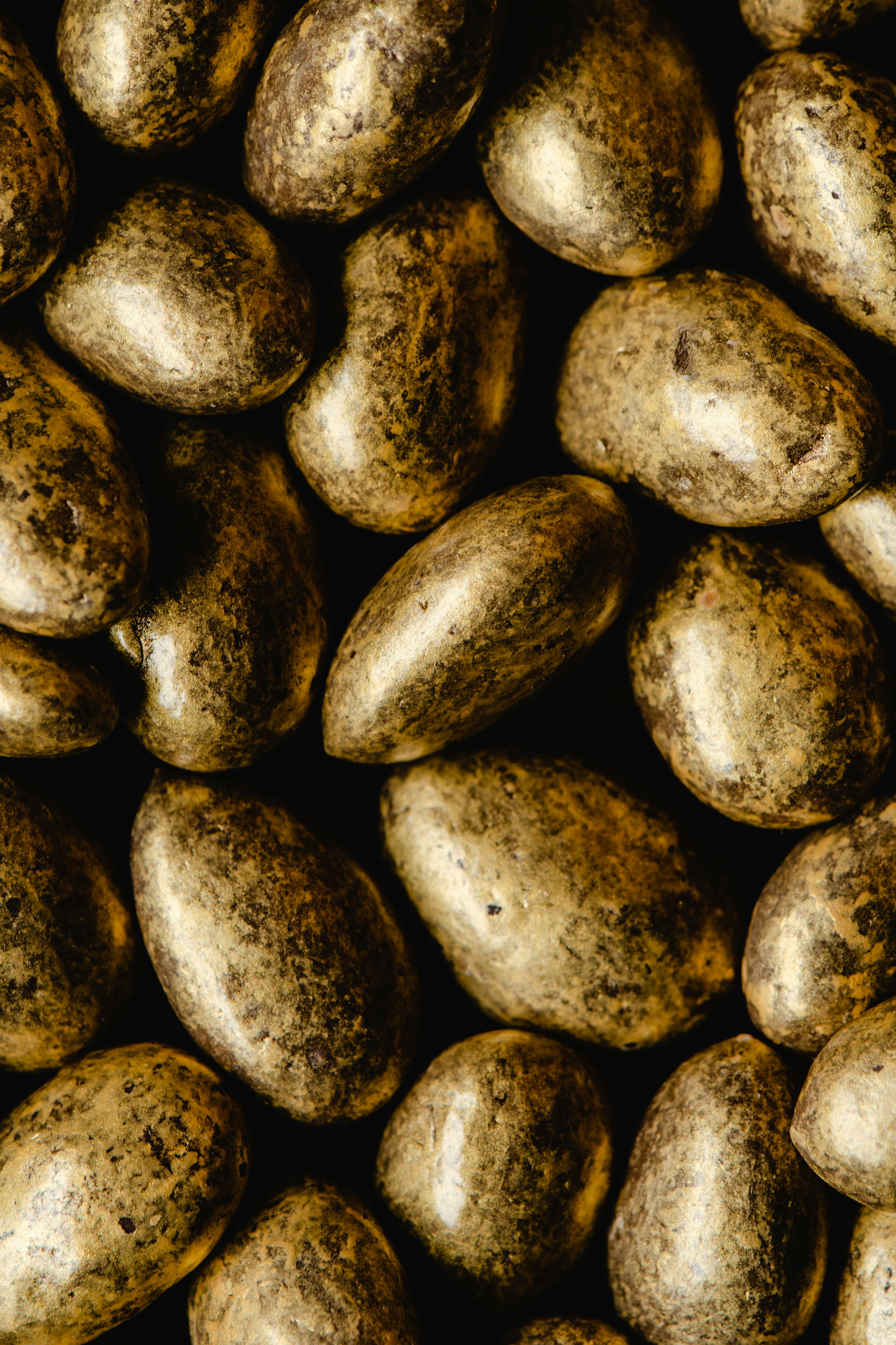 close up photo of gold coated almonds