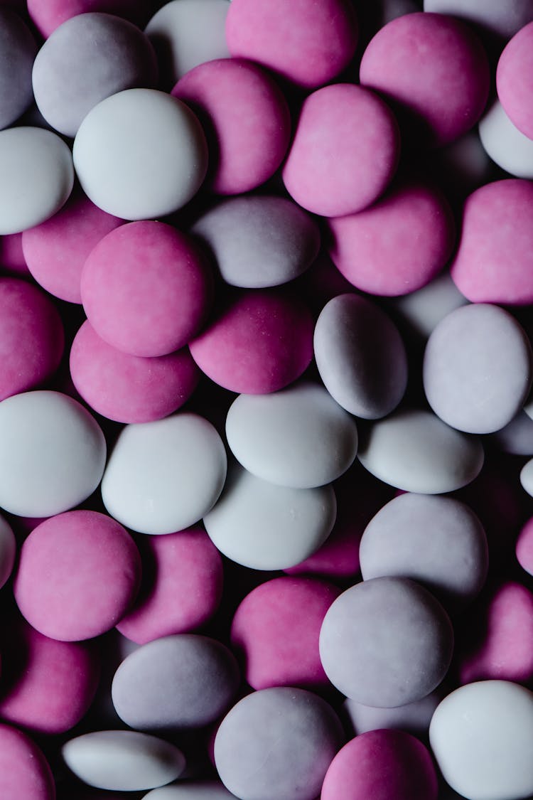 Bunch Of Gray And Purple Flat Round Candies