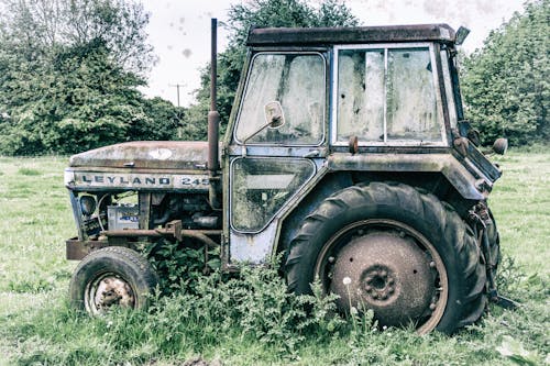 An Abandoned Tractor on a Grassland