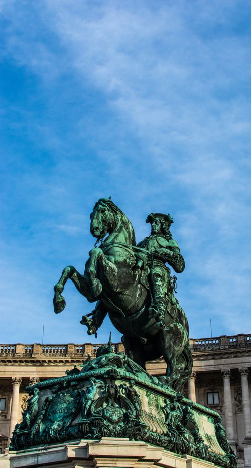 Free A dramatic view of the equestrian statue of Prince Eugene of Savoy in Vienna against a clear blue sky. Stock Photo