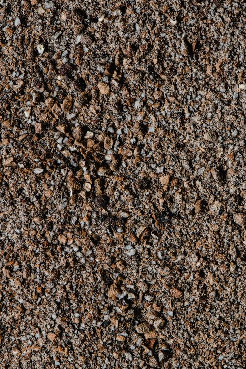 Free Detailed view of a rough textured gravel surface in natural light. Stock Photo