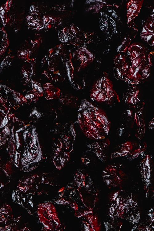 Free Close-up of organic dried raisins showcasing rich texture and nutrition. Stock Photo