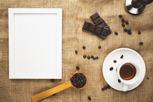 Free Coffee Art with Empty Picture Frame on Brown Fabric Stock Photo