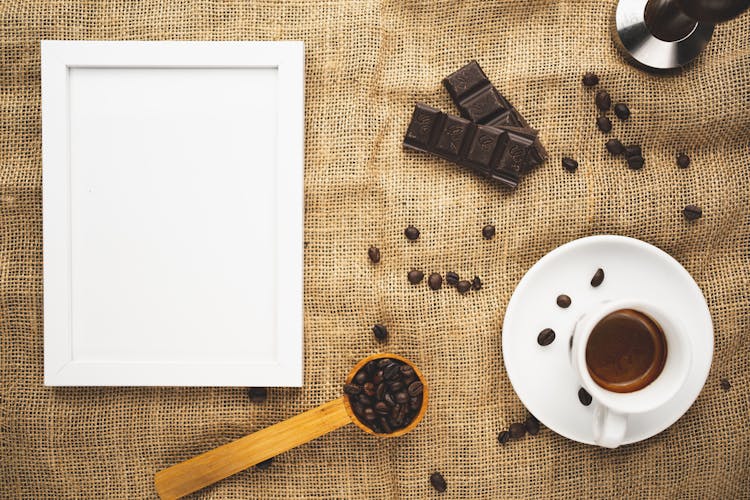 Coffee Art With Empty Picture Frame On Brown Fabric