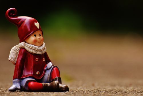 Free Close-up of a cute red dressed winter figurine with a heart hat and scarf. Stock Photo
