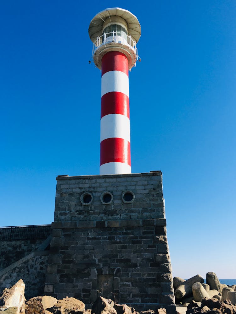 White And Red Tower Under Blue Sky