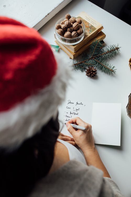 Person Writing On White Paper