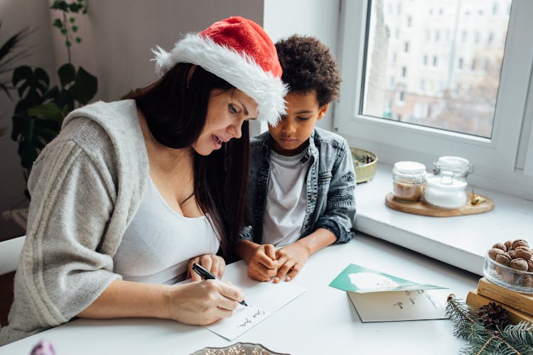 Woman And Boy Writing A Letter 