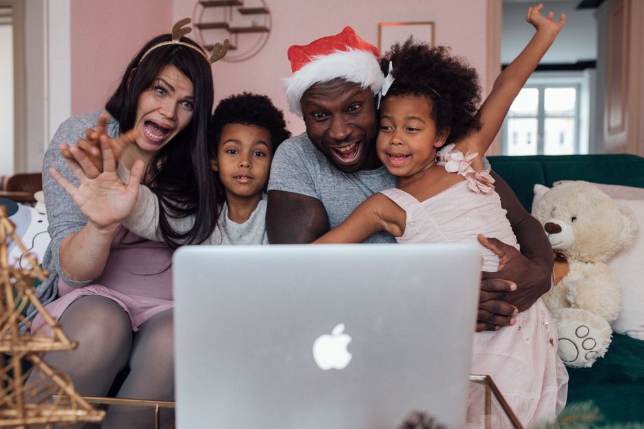 Joyful family enjoying Christmas together with a video call, spreading love and happiness.