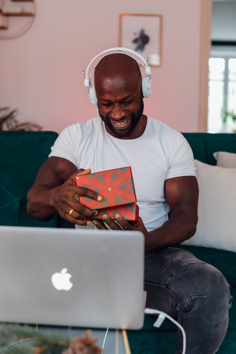 Man In White Crew Neck T-shirt Opening A Gift