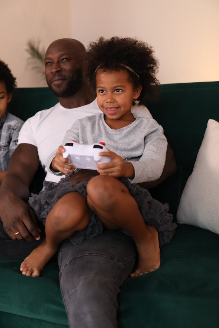 A Family Playing A Game Console