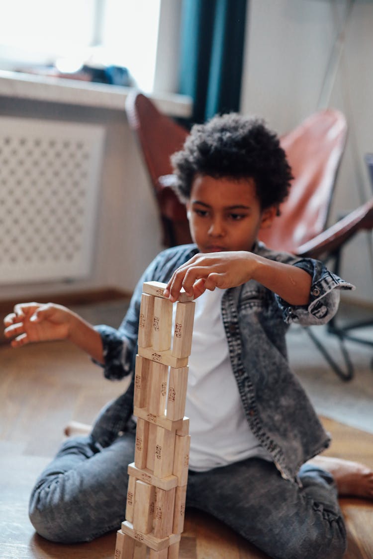 Boy Holding Jenga Block