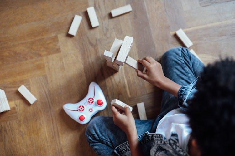 Person Holding Jenga Blocks