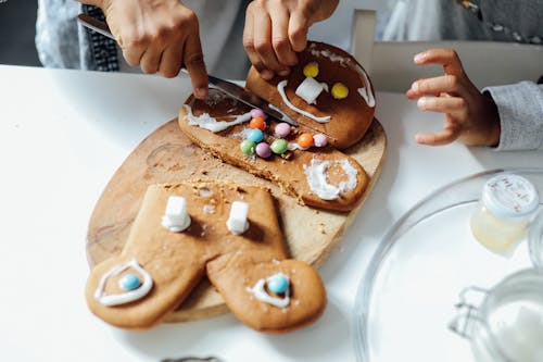 People Decorating A Cookie