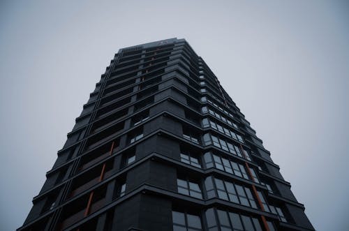 Black Concrete Building Under Blue and Gray Sky