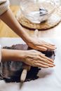 A Person Flattening a Chocolate Flavored Dough