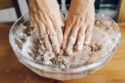 A Person Holding Kneading Dough