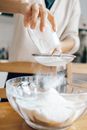 Person Pouring Water on Clear Glass Bowl