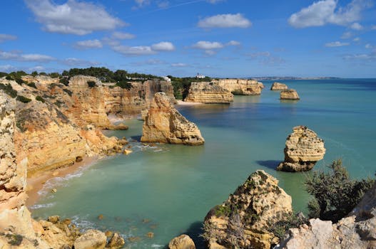 Breathtaking view of Marinha Beach cliffs and turquoise waters in Algarve, Portugal.