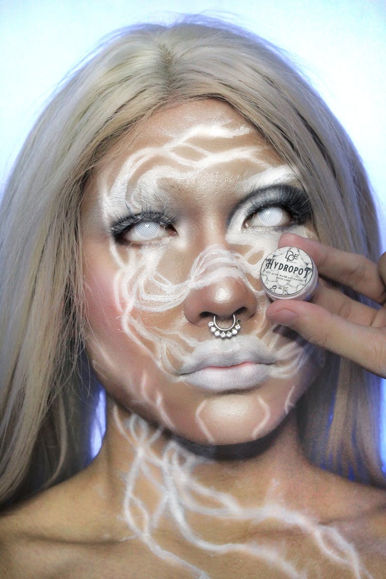 Blonde Woman With Spooky Makeup Nose Piercing And White Contact Lenses