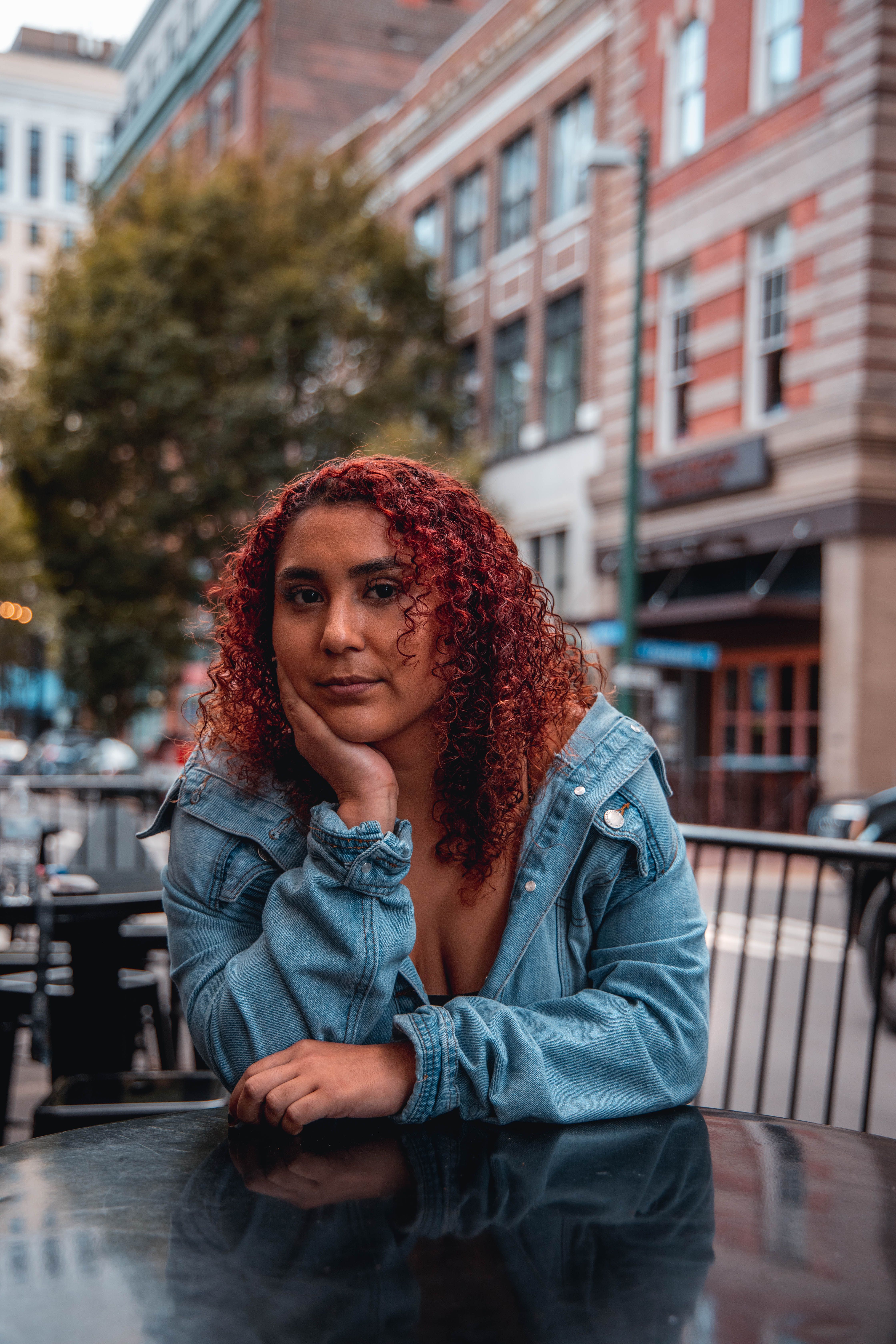 Woman in Blue Denim Jacket Sitting on Bench · Free Stock Photo