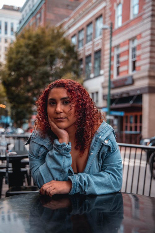 Woman in Blue Denim Jacket Sitting on Bench