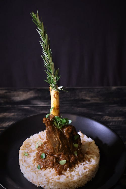 Green Leaf in Bone with Cooked Brown Meat on Rice