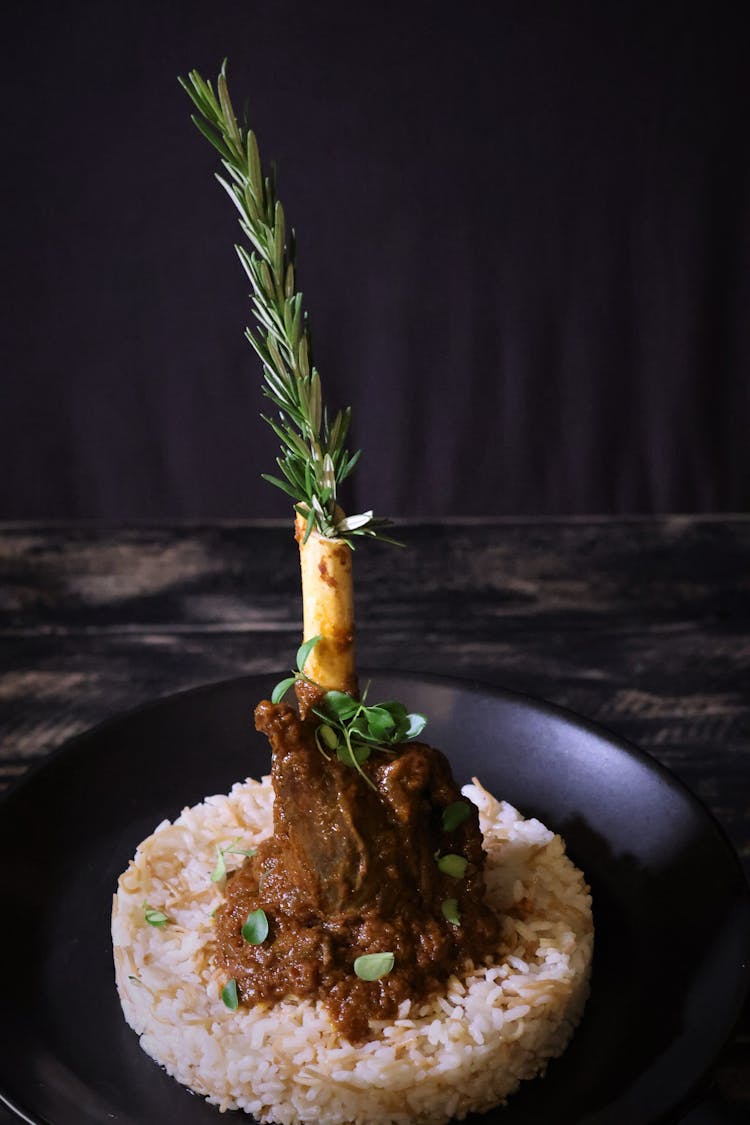 Green Leaf In Bone With Cooked Brown Meat On Rice