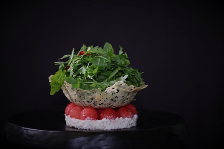 Green Vegetable Salad On Top Of Red Cherry Tomatoes