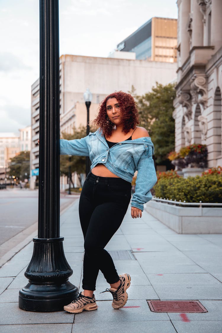 Pretty Woman Holding A Street Pole