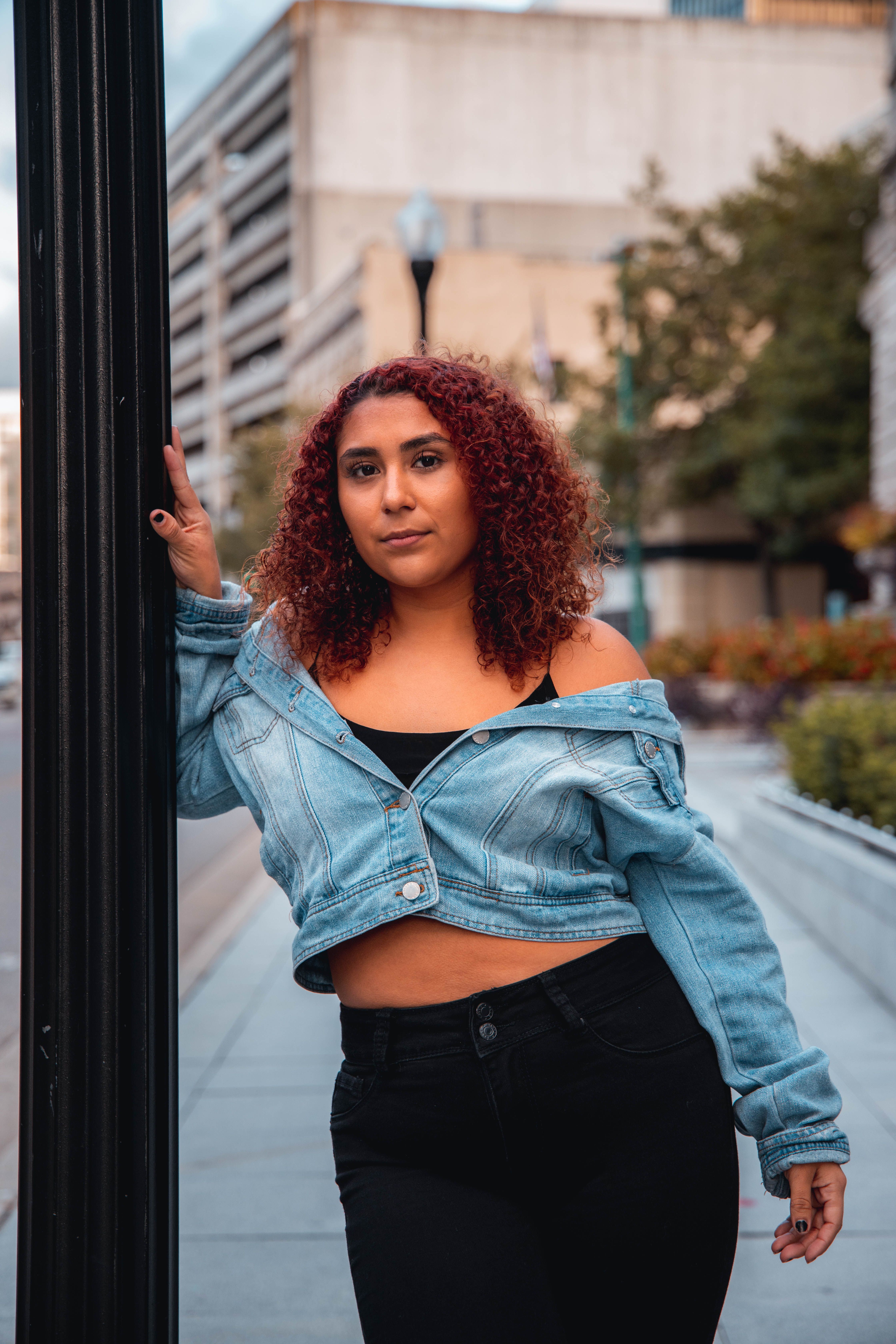 Woman in Blue Denim Jacket Standing on the Street · Free Stock Photo