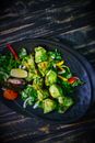 Green Vegetable on Black Round Plate
