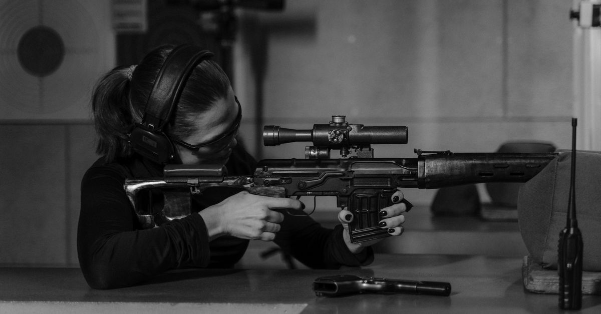 A Woman Holding a Rifle · Free Stock Photo