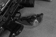 Safety Glasses next to a Rifle