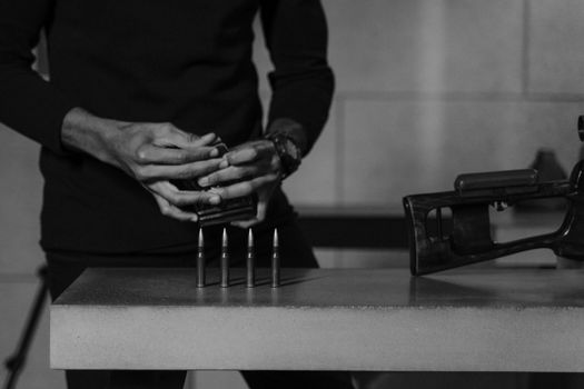 Grayscale Photo of Bullets on Concrete Surface