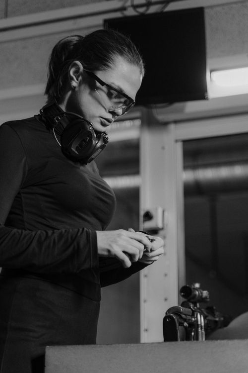 Person putting on safety glasses and ear protection before shooting practice