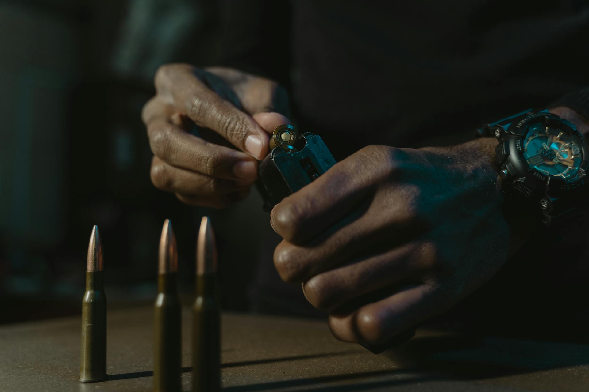 Hands Putting the Cartridges Inside the Magazine