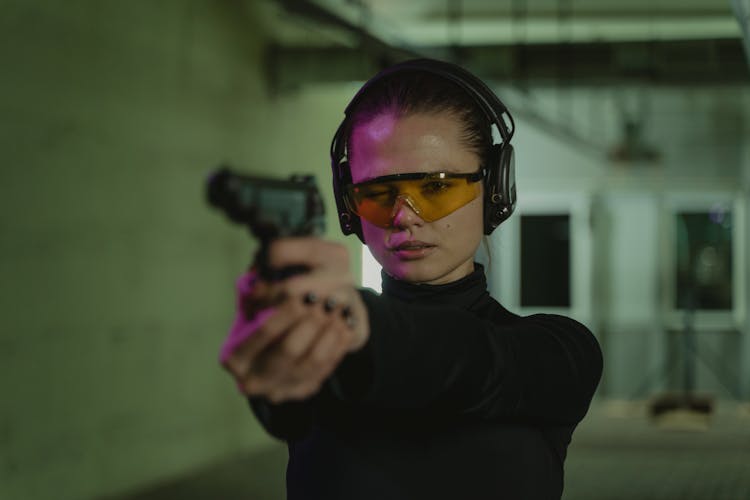 A Woman Holding A Gun 