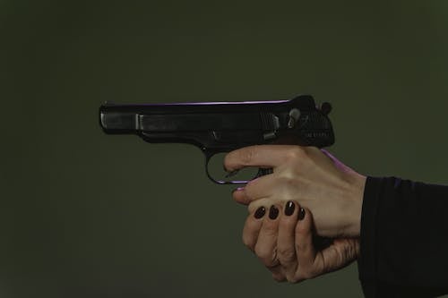 A Person Holding a Pistol