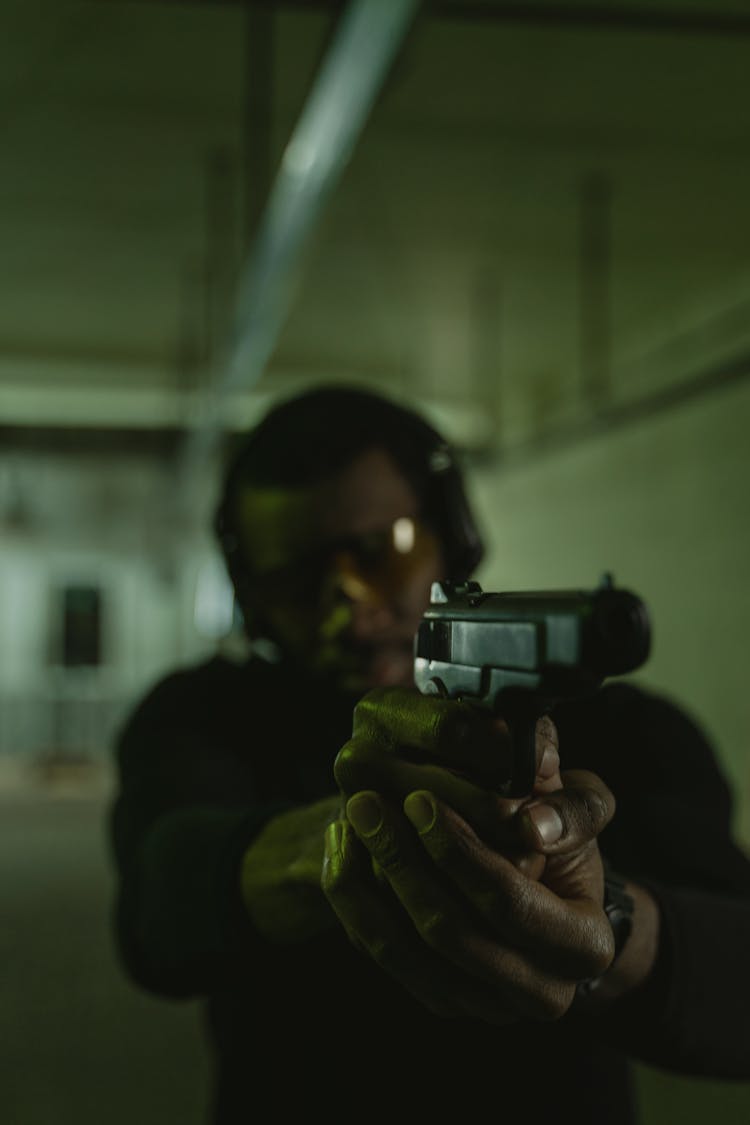 Man Holding A Gun In The Shooting Range