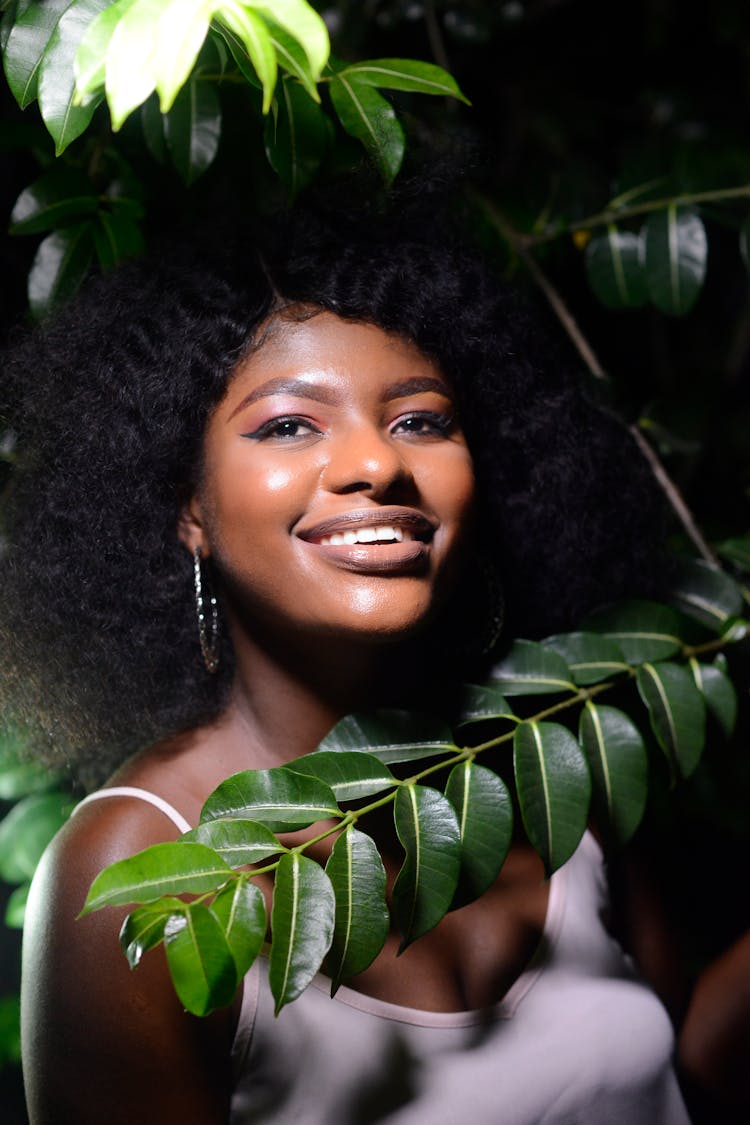 Beautiful Smiling Woman With Black Curly Hair In Garden