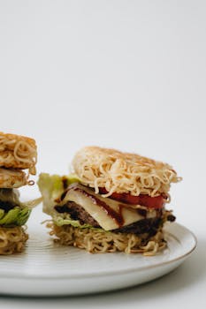 Delicious ramen burgers with cheese and veggies on a ceramic plate, studio shoot.