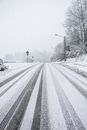 Person in Black Jacket Walking on Snow Covered Road