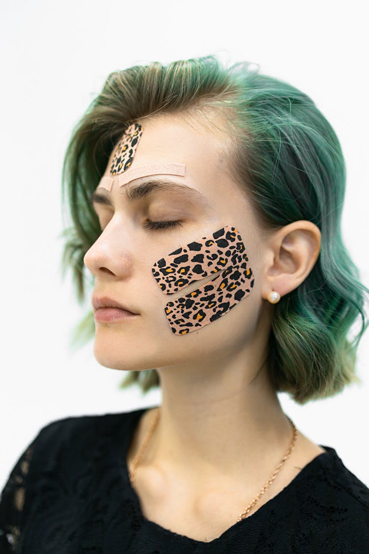 A Woman With Kinesio Tape On Her Face 