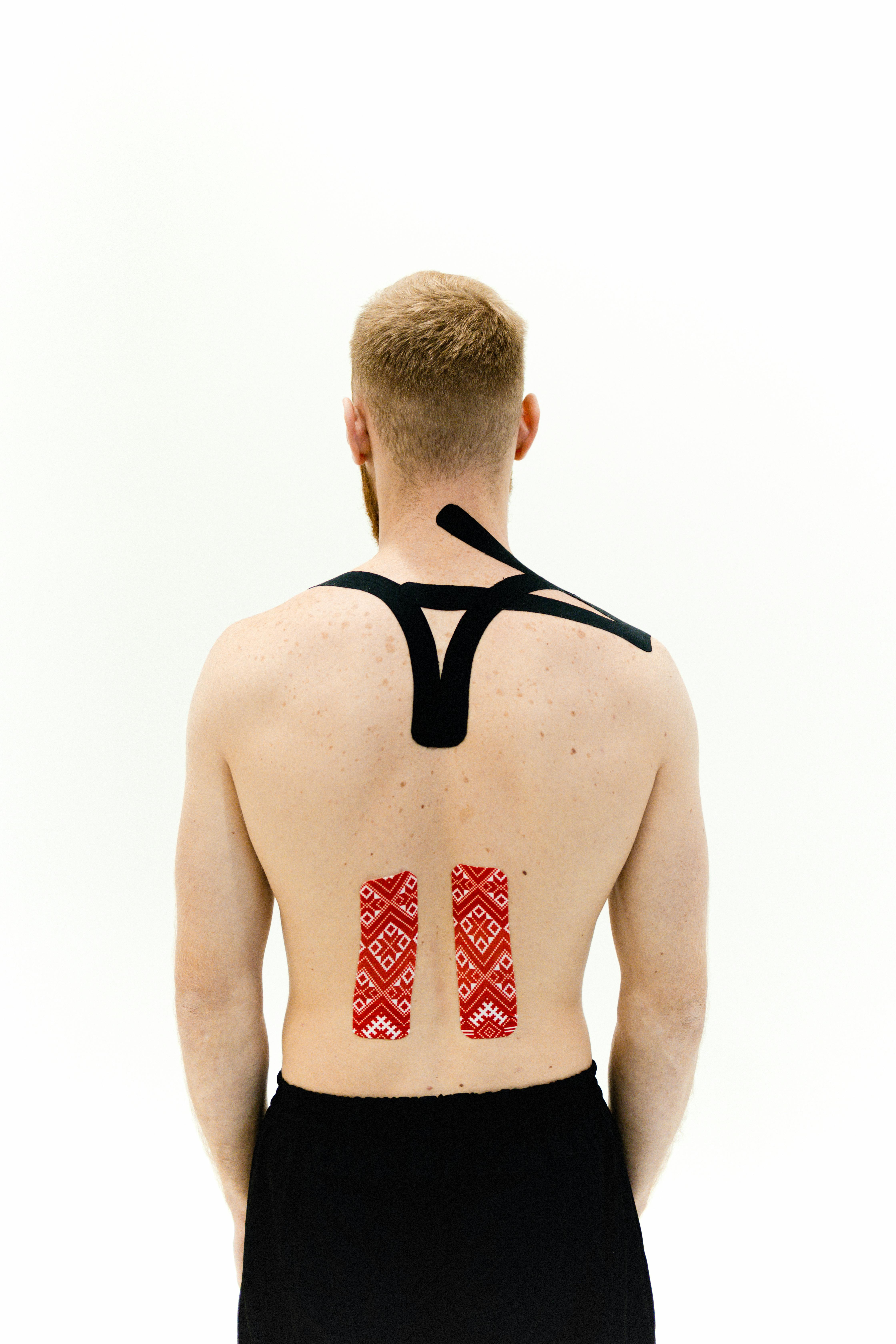 a man with medical tapes on his back