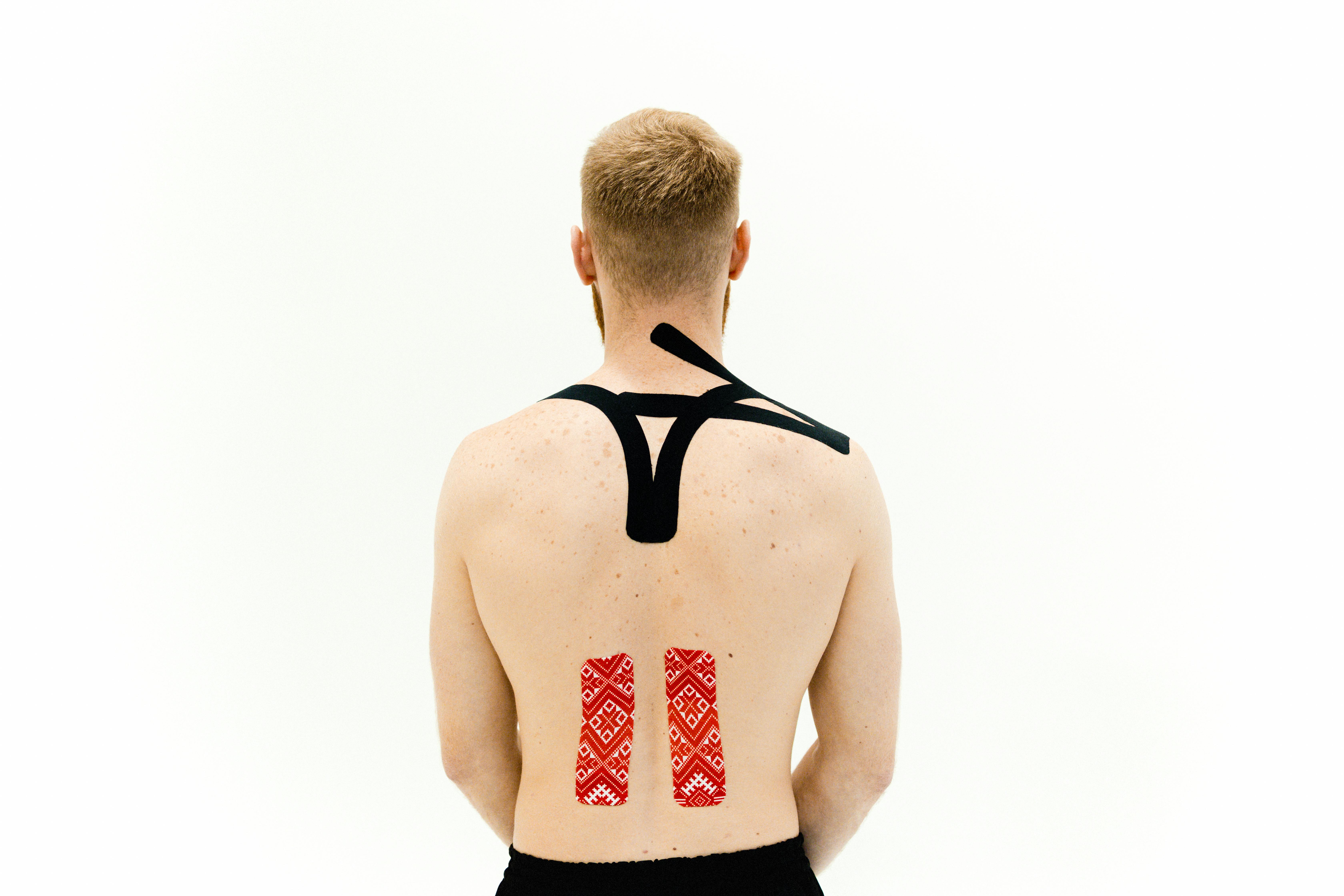 kinseio tapes treatment on a man s back