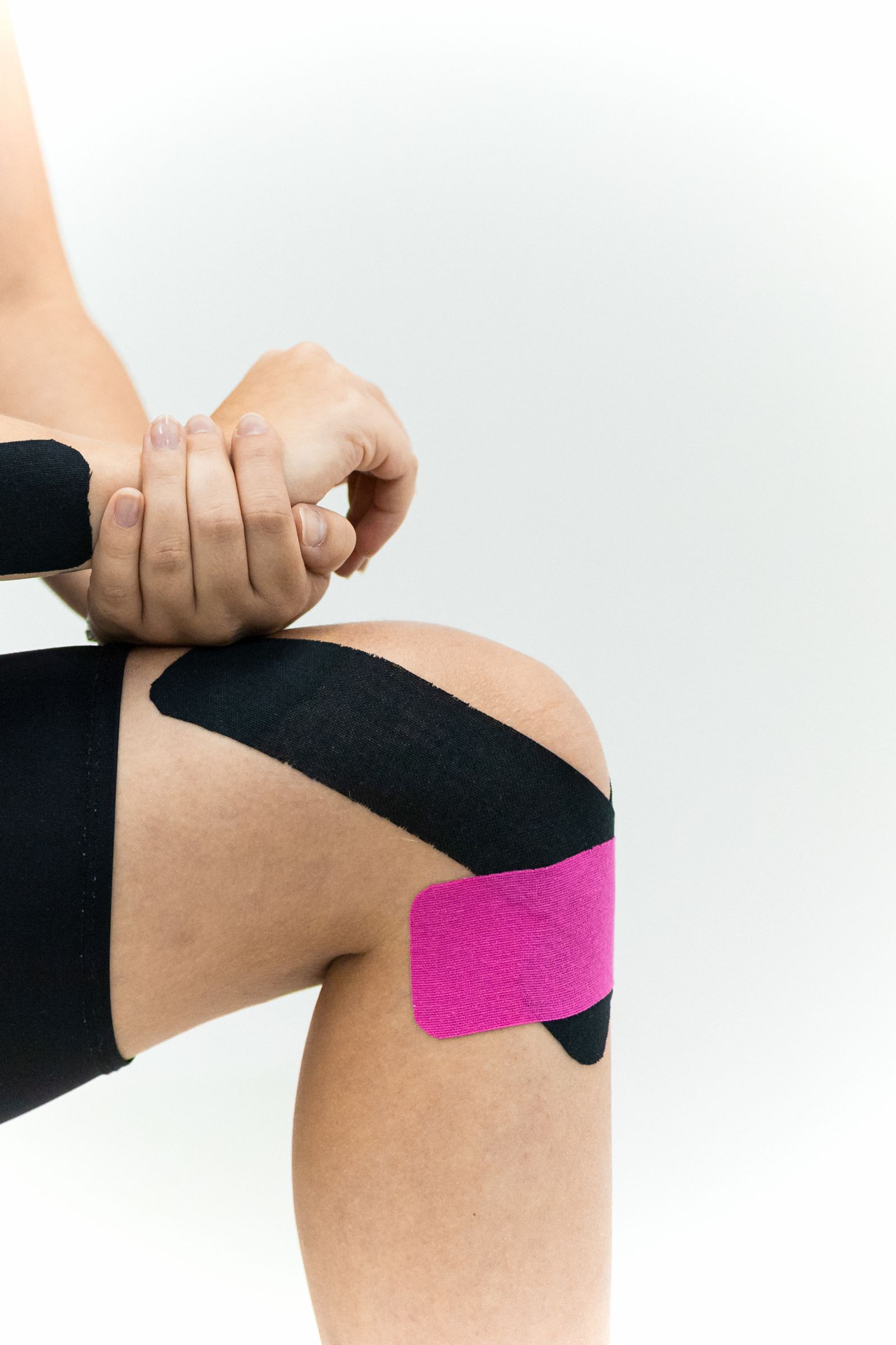 Close-up of a knee with kinesiology tape used during injury treatment