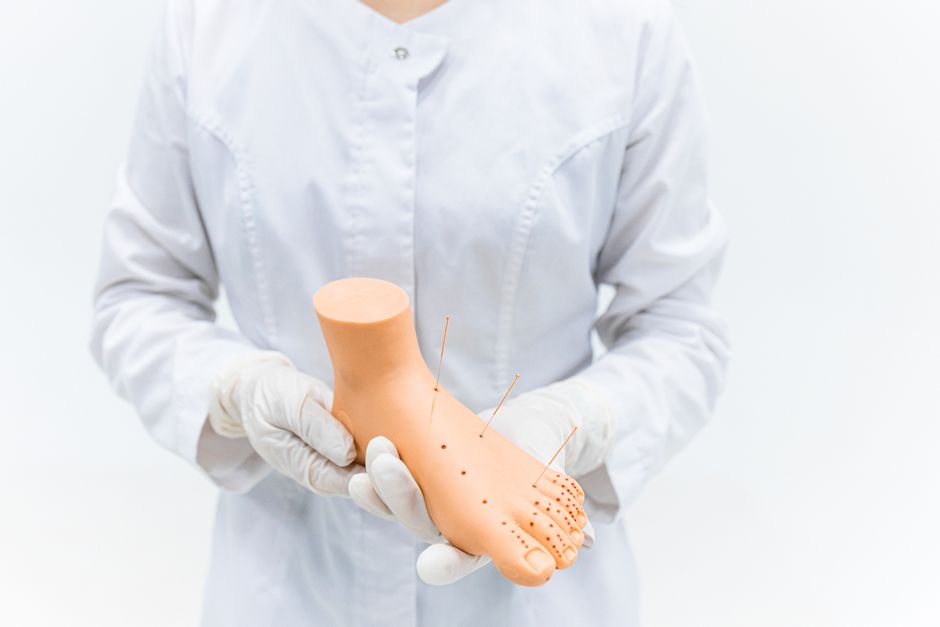 therapist applying pressure foot reflexology