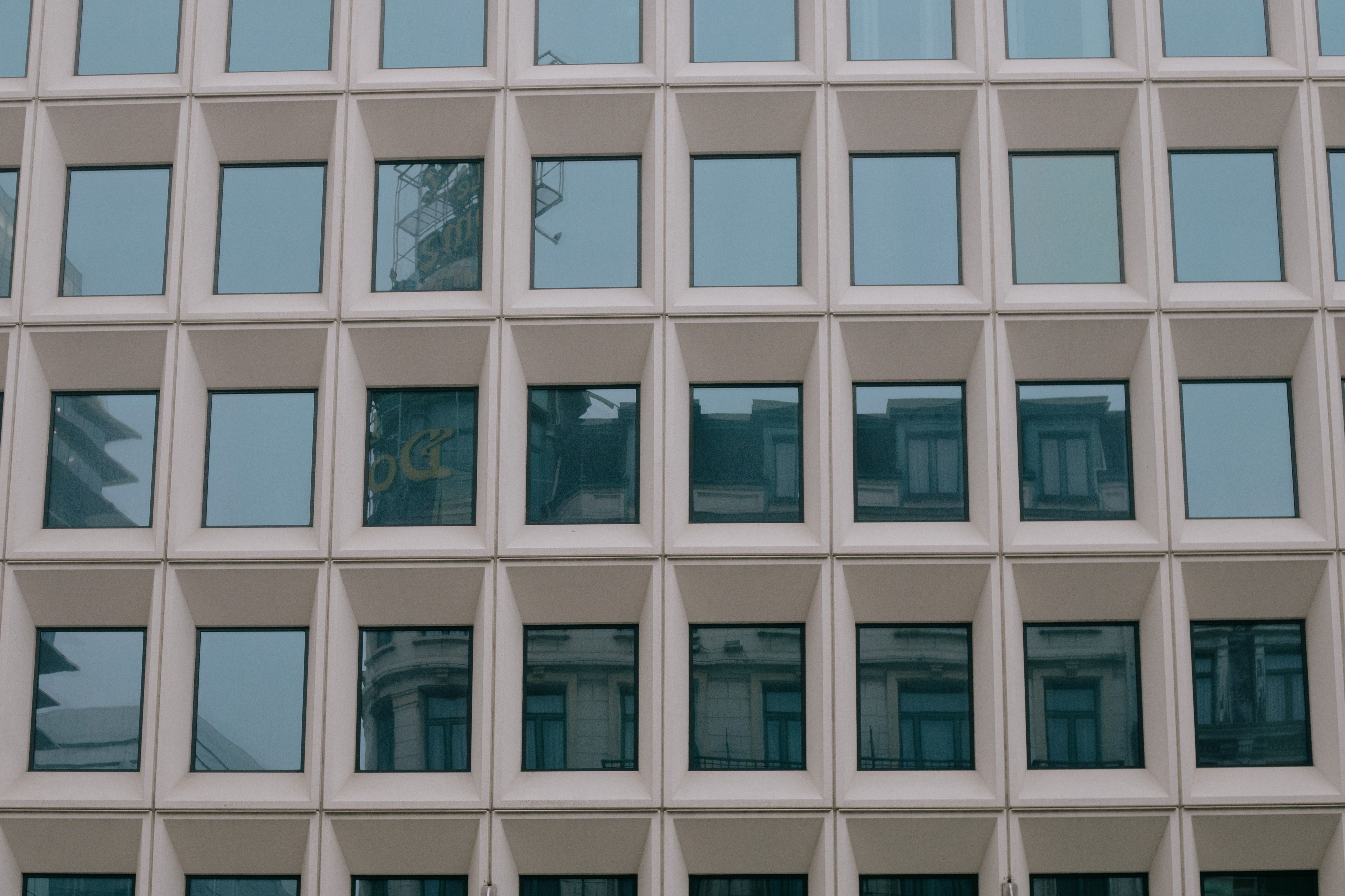 Facade of modern multistory building with symmetric windows · Free ...