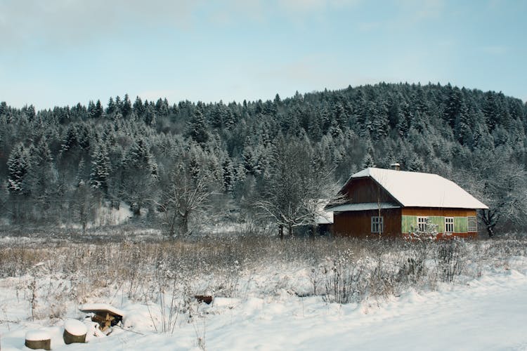 Old Wooden House In Winter Mountain Landscape